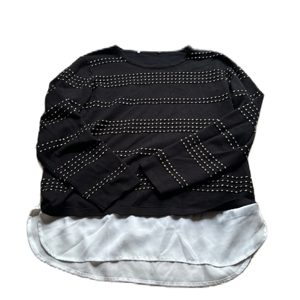 Black striped sweater with faux button up white blouse on bottom.